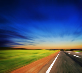 blured road and blue sky