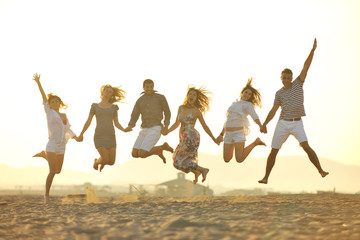 happy young  people group have fun on beach