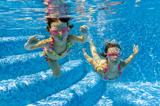 Two underwater kids in swimming pool