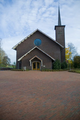 a view of church with white clouds behind, at de glind.