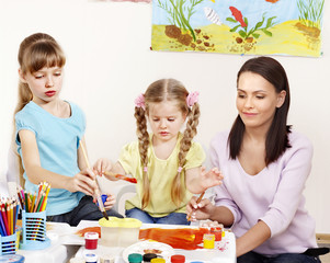 Kids painting in preschool.
