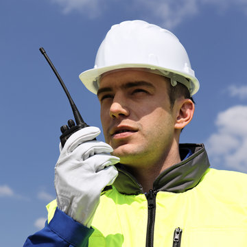 portrait of builder with transmitter in building site