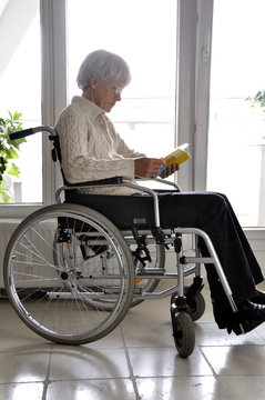 Older Woman in Wheelchair reading
