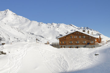 Winter landscape in high Val Martello with mountain refuge