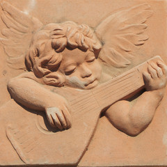 angel playing guitar in terracotta from tuscan Impruneta