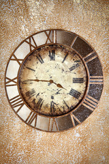 Ancient vintage clock on grunge wall