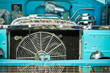 engine bay and radiator grille of an classic old american car