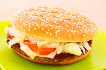 hamburger with vegetables on the table