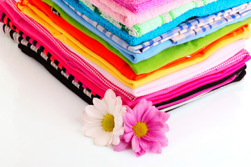 Pile of colorful clothes over white background