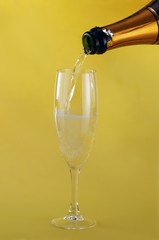 Filling a glass with Champagne
