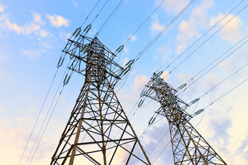 High voltage electric power supplay lines with bright sunset clo