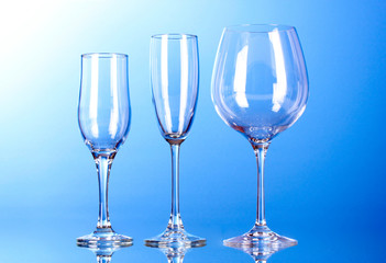 Few empty wine glasses on blue background