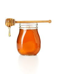 honey dripping from drizzler on top of jar