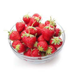Fresh strawberries in a glass dish on white.