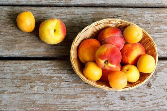 Juicy nectarines and apricots in basket