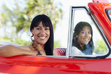 beautiful twin sisters in cabriolet car