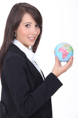 Young woman holding globe