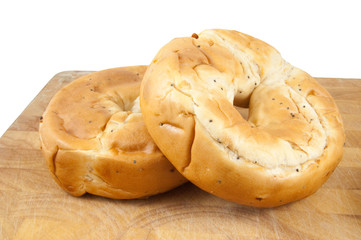 two bagels on chopping board isolated on white