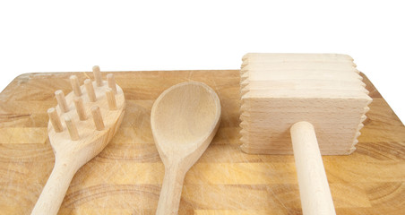 kitchen tools on chopping board on white background