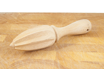 lemon juicer on chopping board on white background