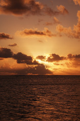 Fototapeta na wymiar Sunset behind dark Clouds over Sea