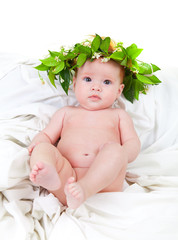 baby with red hair with a crown of jasmine