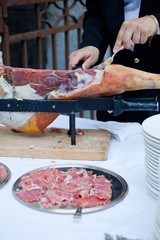 Waiter while slicing jamon