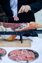 Waiter while slicing jamon