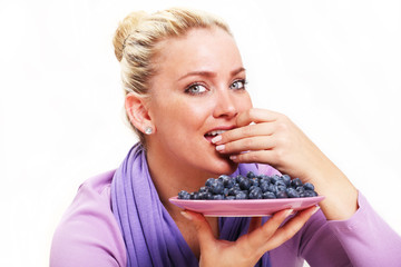 Beautiful Young Woman Eating Blueberries