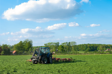 farmer mowing grass