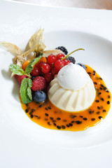 Vanilla ice cream decorated with fresh mint and cherry