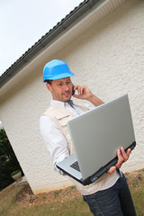 Entrepreneur using telephone and laptop computer