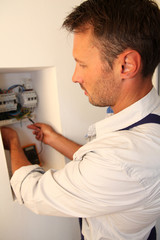 Electrician installing electric meter