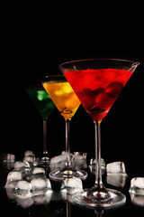 Martini drinks with ice on black background