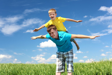 father with son in summer day outdoors