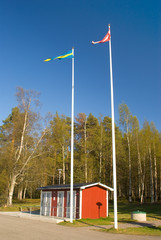 Flag of Sweden and Denmark on the background of the park