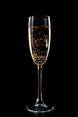 Glass with champagne on black background