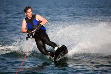 sliding wakeboarder  in water splash