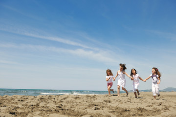 Fototapeta na wymiar happy child group playing on beach