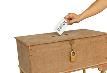 A man's hand putting an envelope in the slot of a box