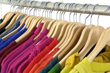Line of colorful shirt rack on white