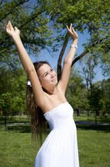 The young girl has lifted hands and rejoices lives