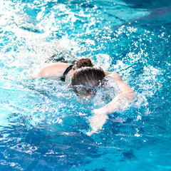Swimmer woman performing the crawl stroke