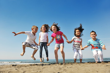 happy child group playing  on beach