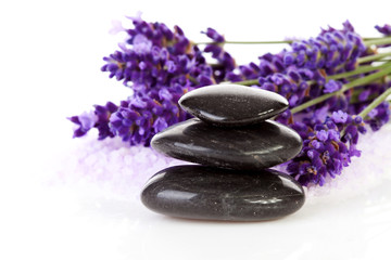 Fototapeta na wymiar stacked black stepping stones and lavender flowers
