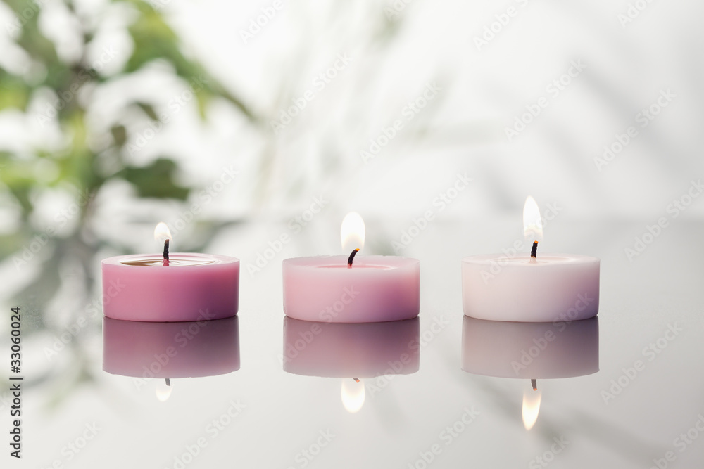 Poster lighted candles on a mirror