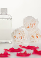Pink petals with a glass flask and roses