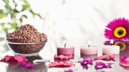 Obraz na płótnie Canvas Lighted pink candles with petals and a bowl of gravel