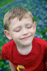 Boy smiling in a Bluebonnet field