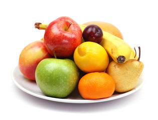 fruit plate with citrus fruits, apples, banana, plum